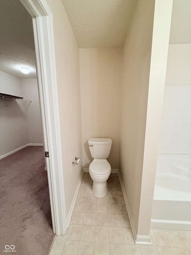 bathroom featuring a textured ceiling and toilet