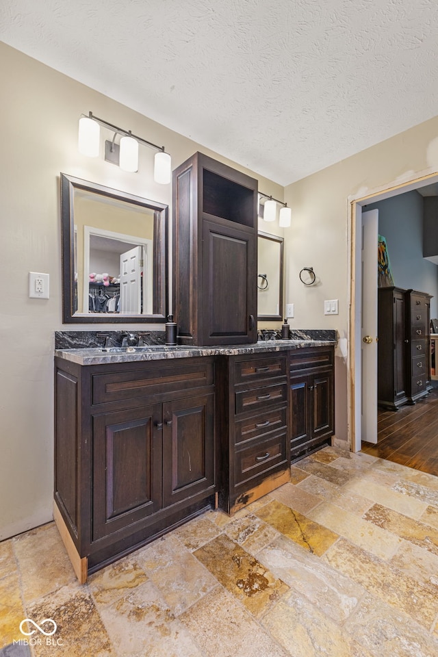 bathroom featuring vanity and a textured ceiling