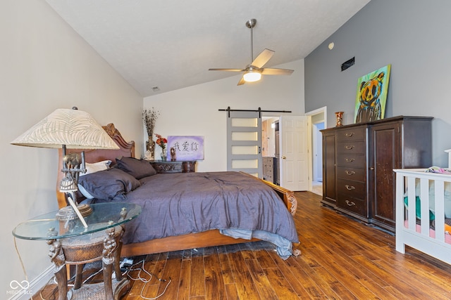 bedroom with ceiling fan, a barn door, dark wood-type flooring, and high vaulted ceiling