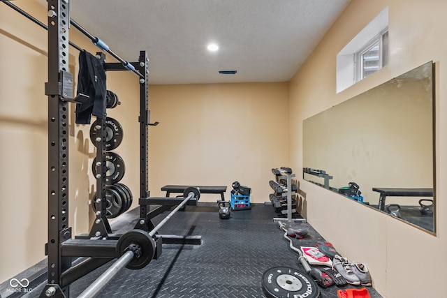 workout room with a textured ceiling