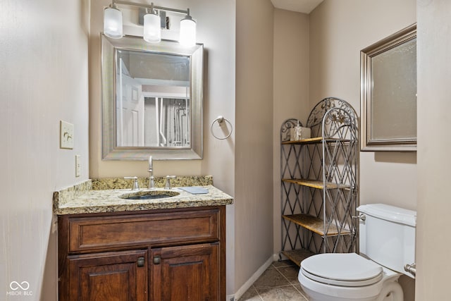 bathroom with tile patterned flooring, vanity, and toilet