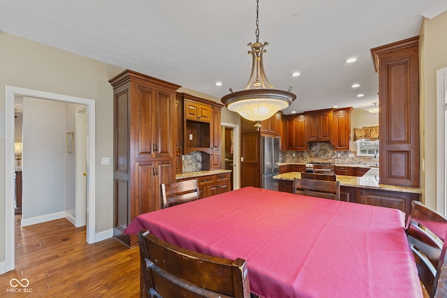 dining area with dark hardwood / wood-style floors