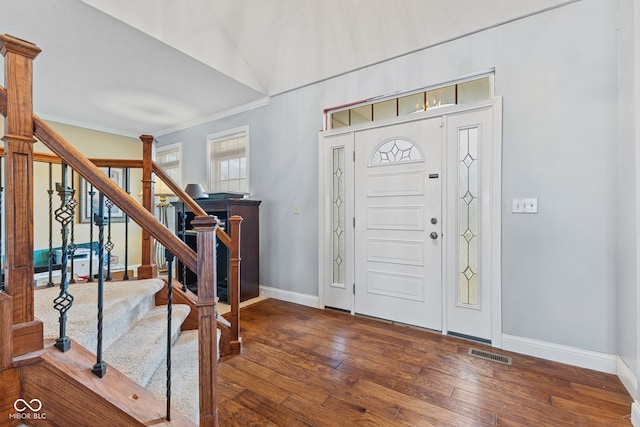 entryway with crown molding and hardwood / wood-style floors