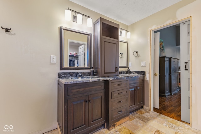 bathroom with vanity and a textured ceiling