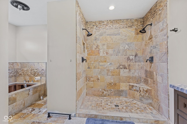 bathroom featuring vanity and a tile shower