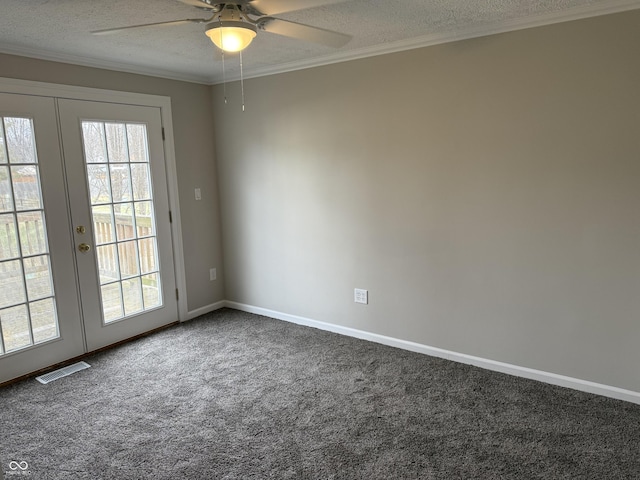 empty room with a textured ceiling, ornamental molding, a healthy amount of sunlight, and carpet flooring