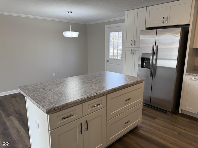 kitchen with a kitchen island, pendant lighting, white cabinetry, crown molding, and stainless steel refrigerator with ice dispenser