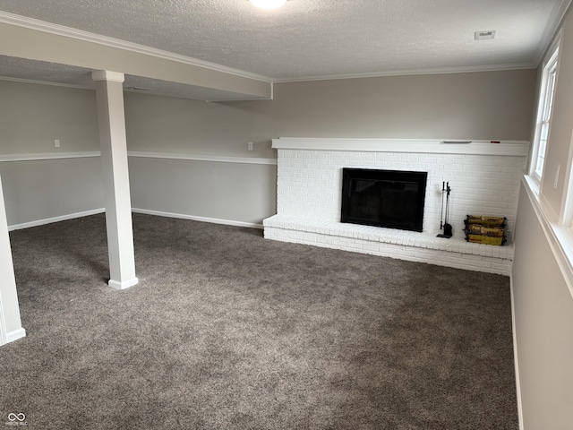 unfurnished living room with ornamental molding, a textured ceiling, a fireplace, and dark carpet