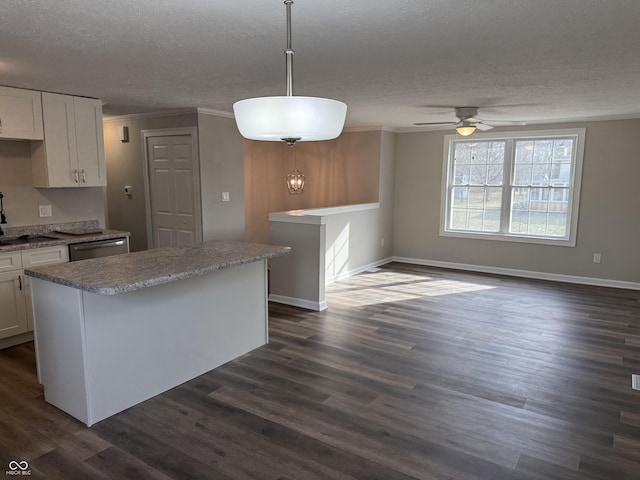 kitchen with white cabinetry, dishwasher, dark hardwood / wood-style flooring, hanging light fixtures, and a textured ceiling