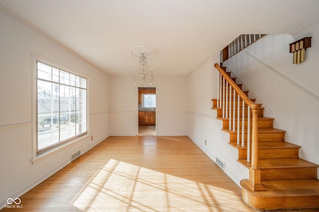 interior space with an inviting chandelier and hardwood / wood-style floors