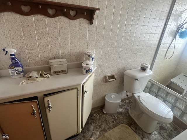 bathroom featuring toilet and tile walls