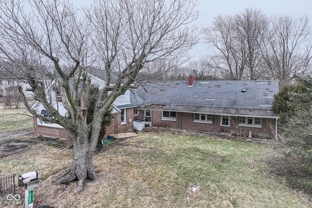 rear view of property with a yard