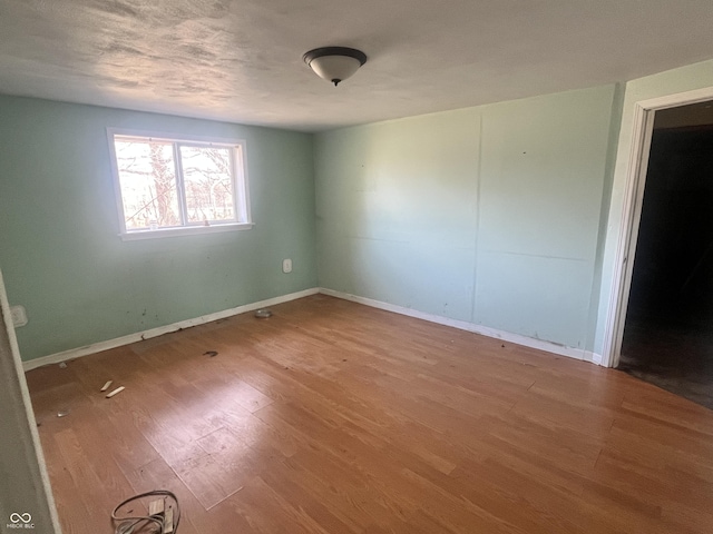 unfurnished room featuring wood-type flooring