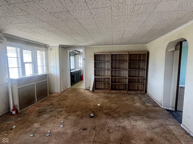 miscellaneous room with ornamental molding and radiator heating unit