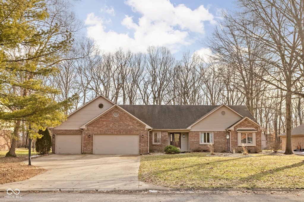 view of front of home with a garage and a front lawn