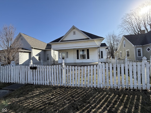 bungalow-style house with a fenced front yard and a porch