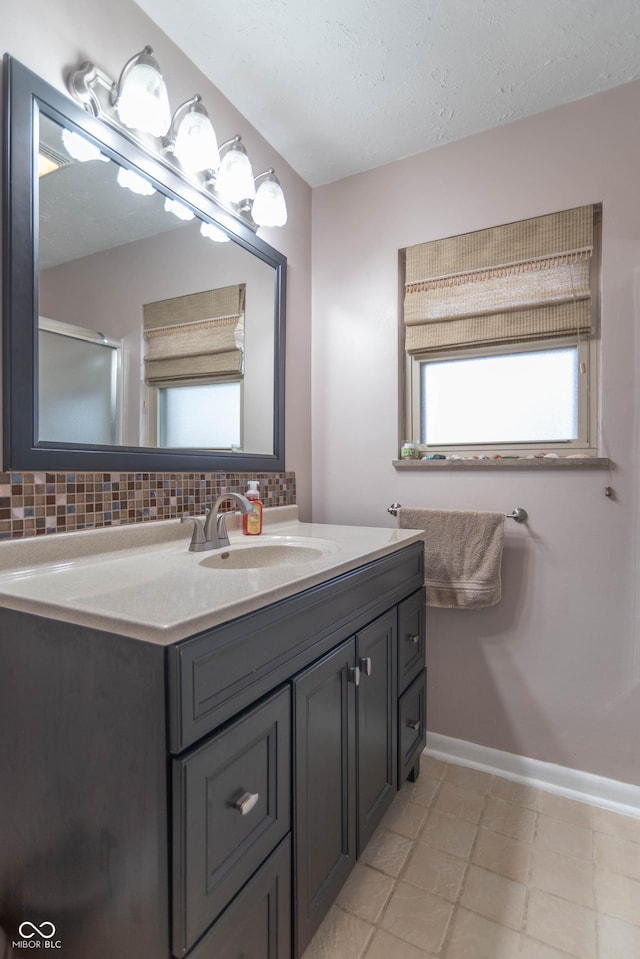 bathroom featuring vanity and backsplash