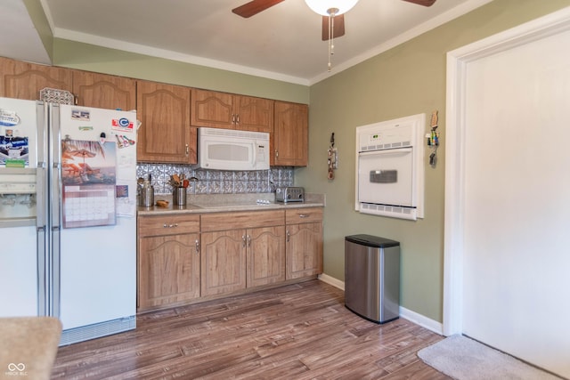 kitchen with tasteful backsplash, wood-type flooring, ornamental molding, ceiling fan, and white appliances