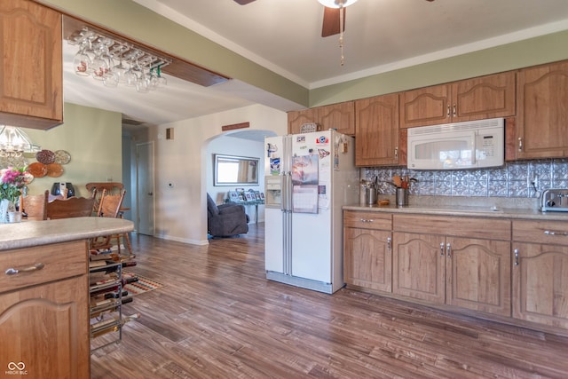 kitchen featuring ceiling fan, white appliances, hardwood / wood-style floors, and decorative backsplash