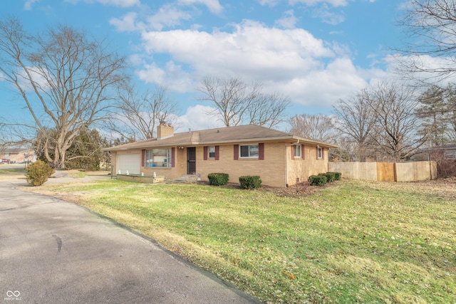 single story home with a garage and a front lawn