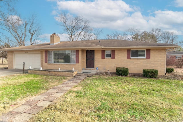 ranch-style home with a garage and a front lawn