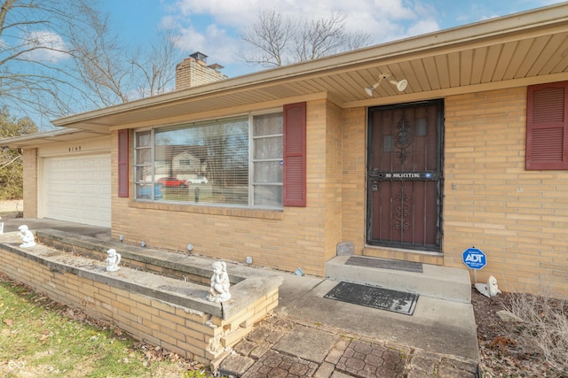 doorway to property featuring a garage