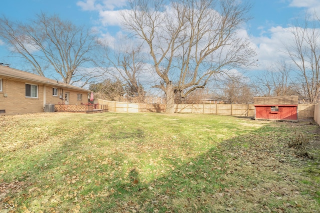 view of yard with central air condition unit and a storage shed