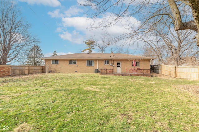 back of property with a wooden deck, a yard, and central AC