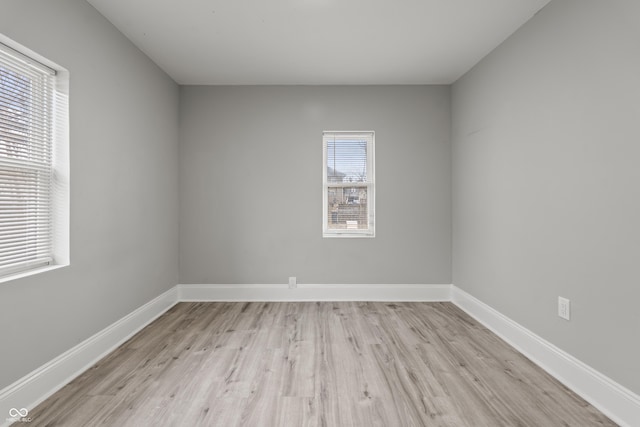 empty room with light hardwood / wood-style flooring