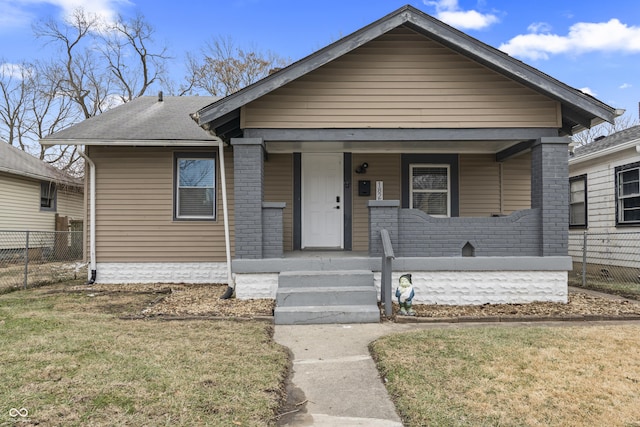 bungalow featuring a porch and a front lawn