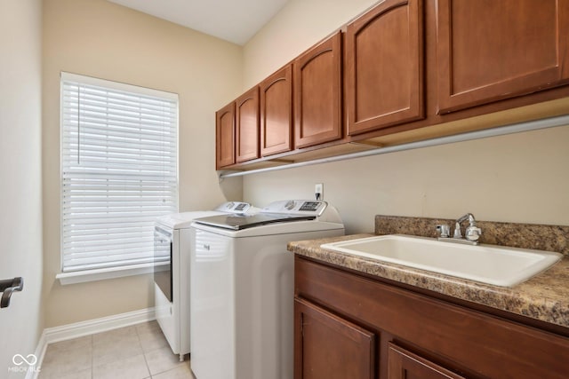 washroom featuring cabinets, light tile patterned flooring, sink, and washer and clothes dryer