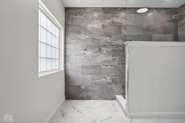 bathroom with tile walls and a shower