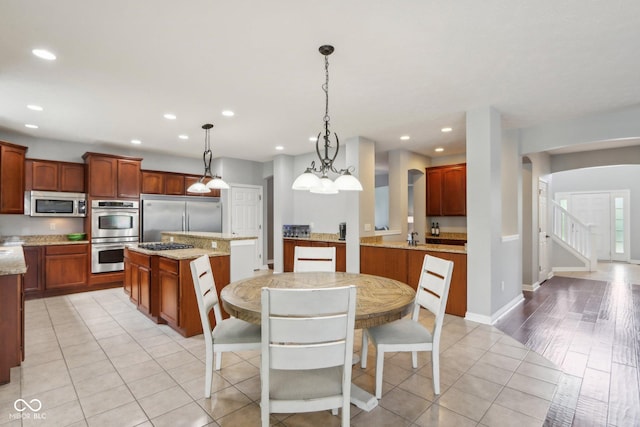 dining area with sink and light tile patterned floors