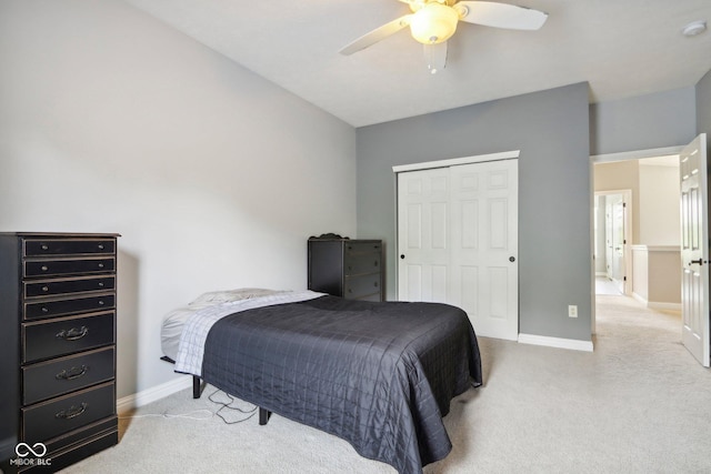 bedroom featuring ceiling fan, a closet, and light carpet