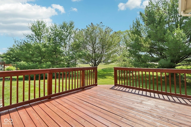 wooden terrace featuring a lawn