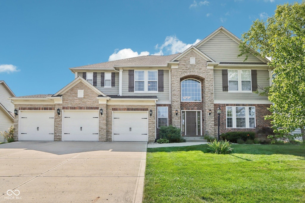 view of front of home featuring a garage and a front yard