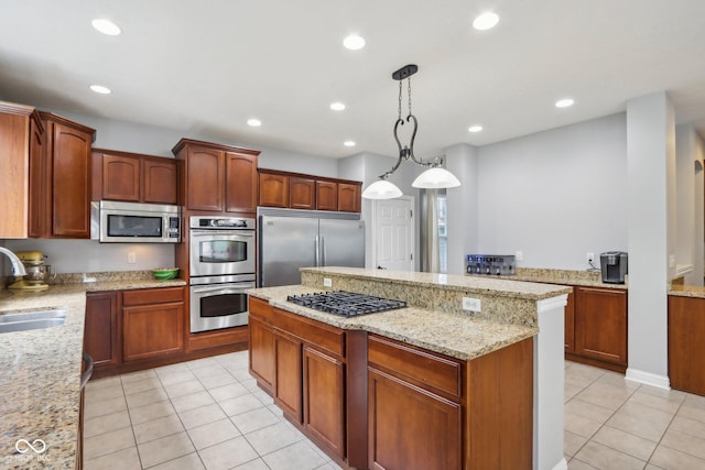 kitchen with light stone countertops, appliances with stainless steel finishes, light tile patterned floors, and decorative light fixtures