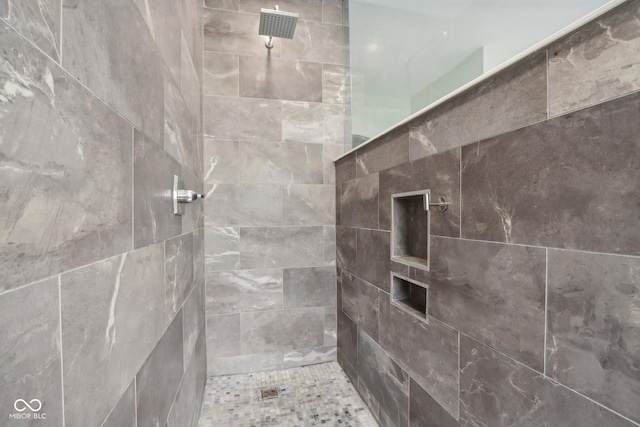 bathroom with a tile shower