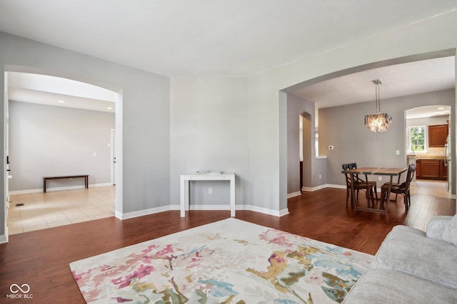 living room featuring hardwood / wood-style flooring and an inviting chandelier