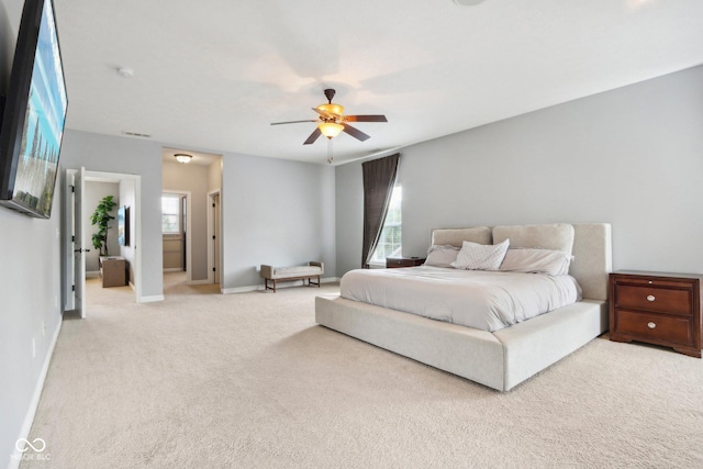 carpeted bedroom with multiple windows and ceiling fan