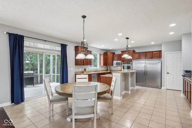 dining room featuring sink and light tile patterned floors