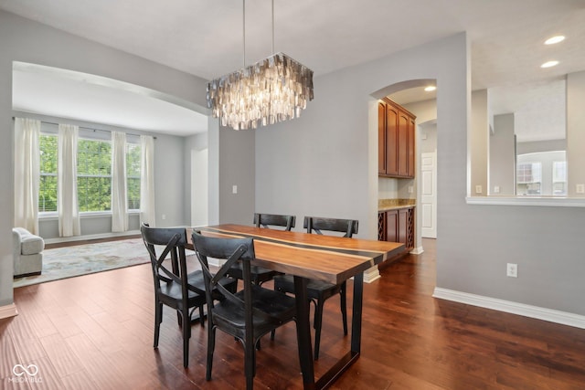 dining space featuring a notable chandelier and dark hardwood / wood-style floors