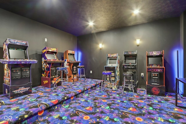 recreation room featuring carpet flooring and a textured ceiling