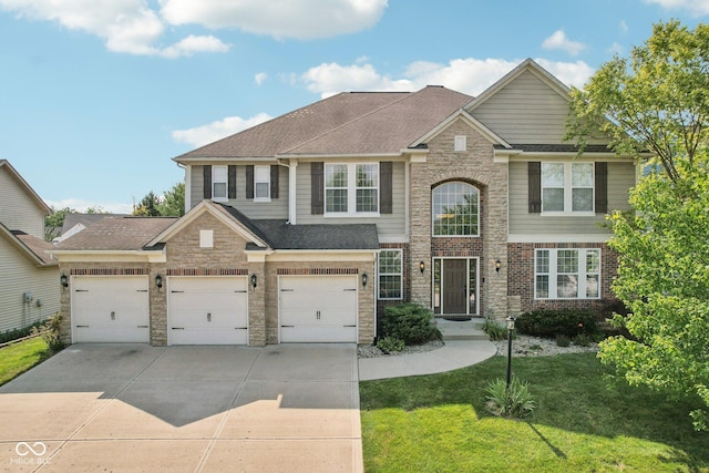 view of front of home with a garage and a front lawn