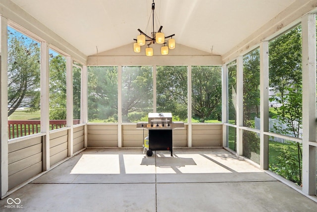 unfurnished sunroom with vaulted ceiling and an inviting chandelier