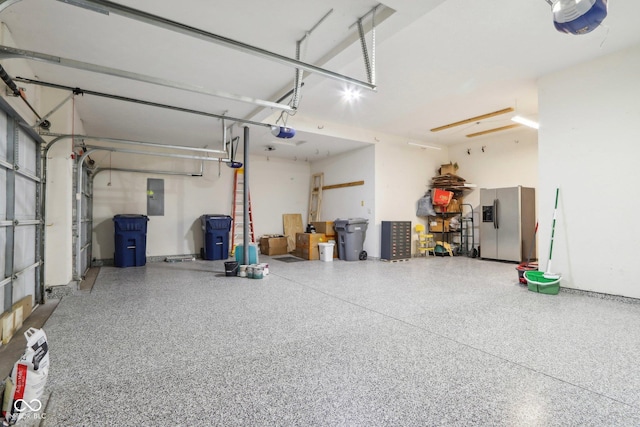 garage featuring a garage door opener, stainless steel fridge, and electric panel