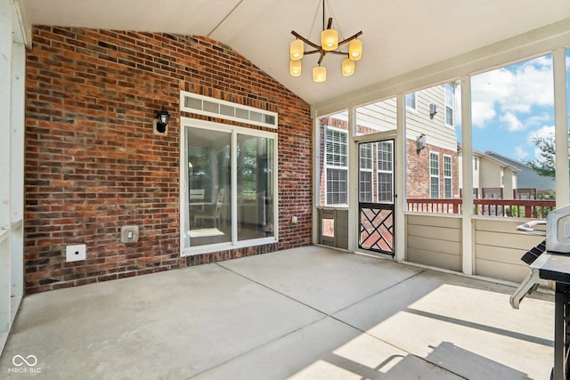 unfurnished sunroom featuring an inviting chandelier and lofted ceiling