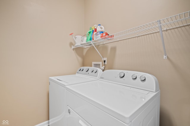 clothes washing area with washing machine and clothes dryer