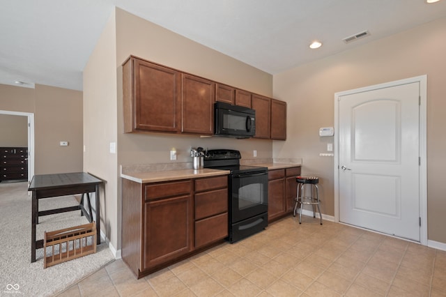 kitchen featuring black appliances and light tile patterned flooring