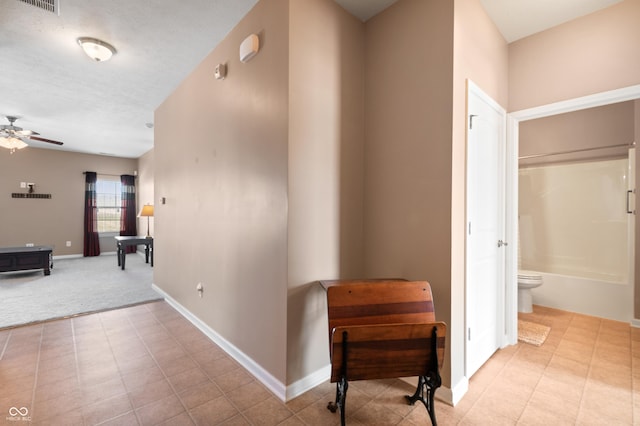 corridor featuring a textured ceiling